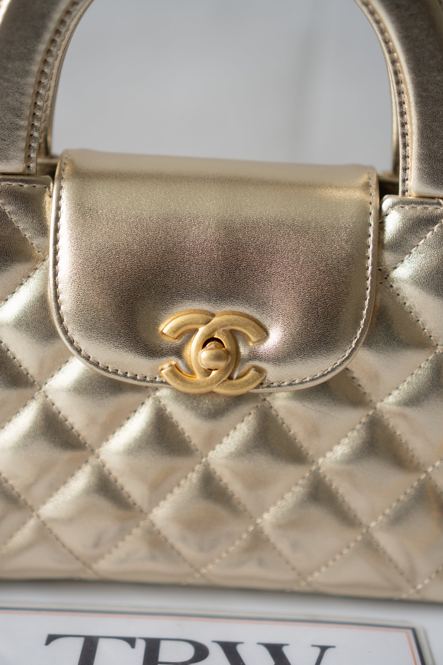 Kelly Top Handle Mini Flap – Metallic Gold Quilted Lambskin with Gold Hardware