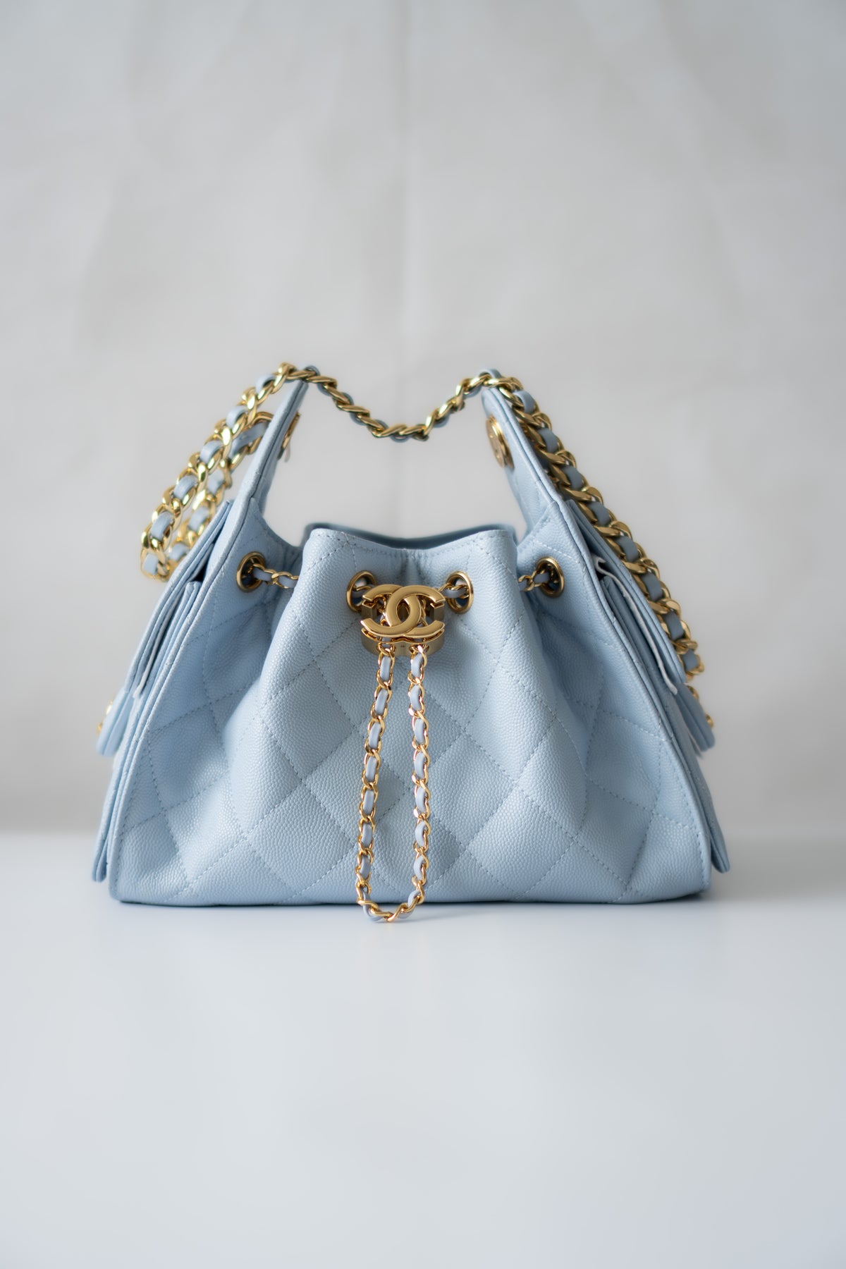 CC Drawstring Bucket Bag – Light Blue Quilted Caviar Leather with Gold Hardware