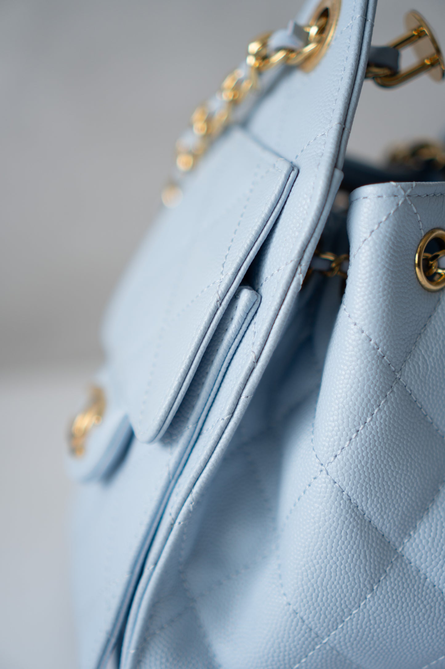 CC Drawstring Bucket Bag – Light Blue Quilted Caviar Leather with Gold Hardware