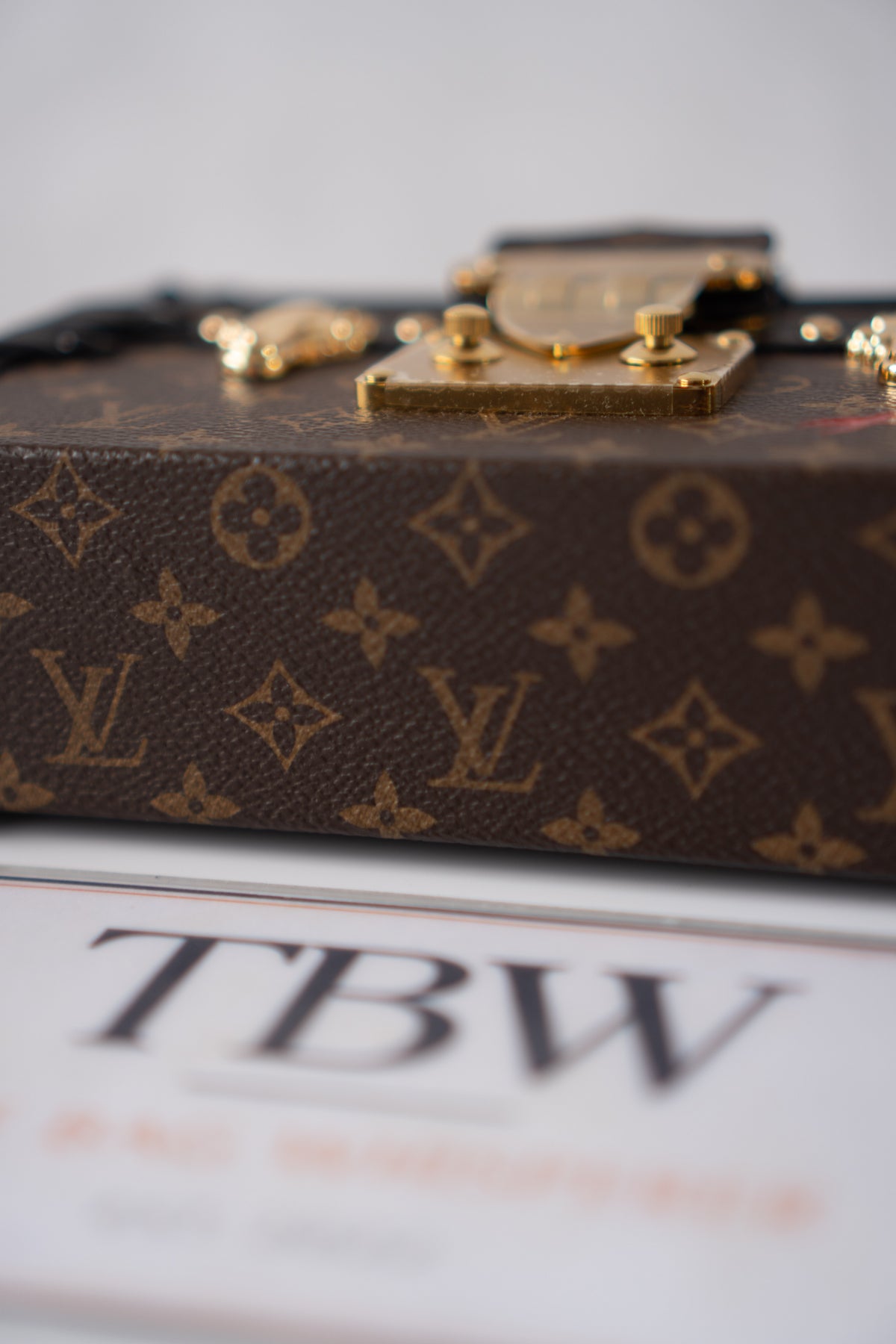 Petite Malle – Monogram Canvas with Black Calfskin & Gold-Tone Hardware