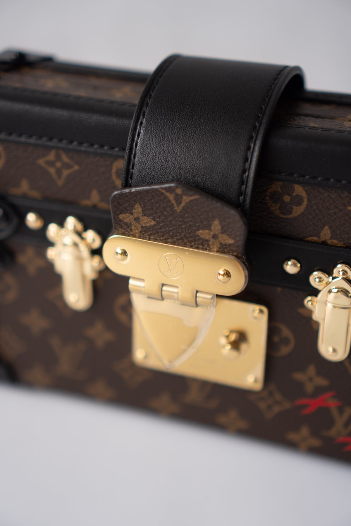 Petite Malle – Monogram Canvas with Black Calfskin & Gold-Tone Hardware