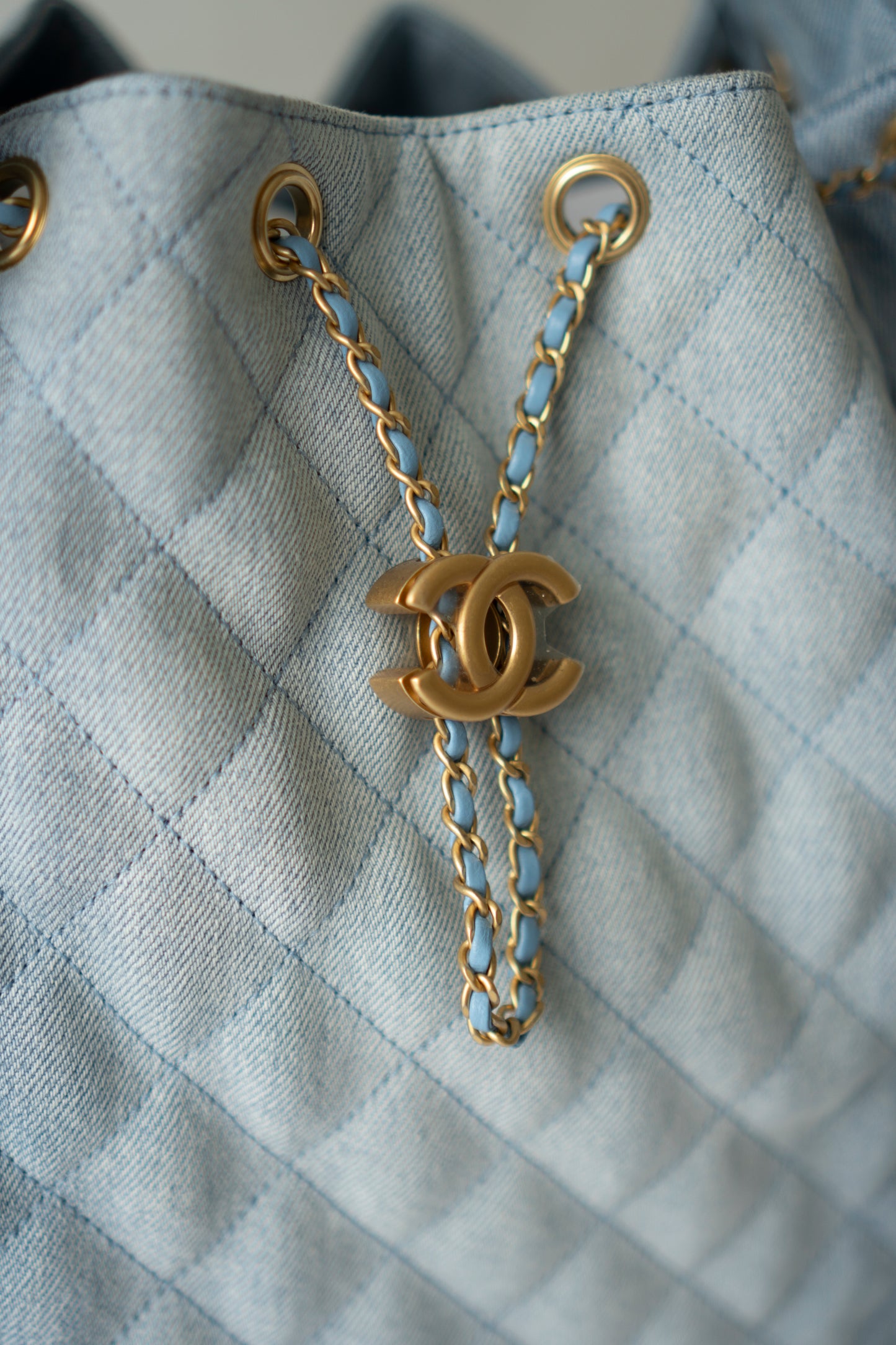 C25 Medium Drawstring Chain Bag – Washed Denim with Gold Hardware