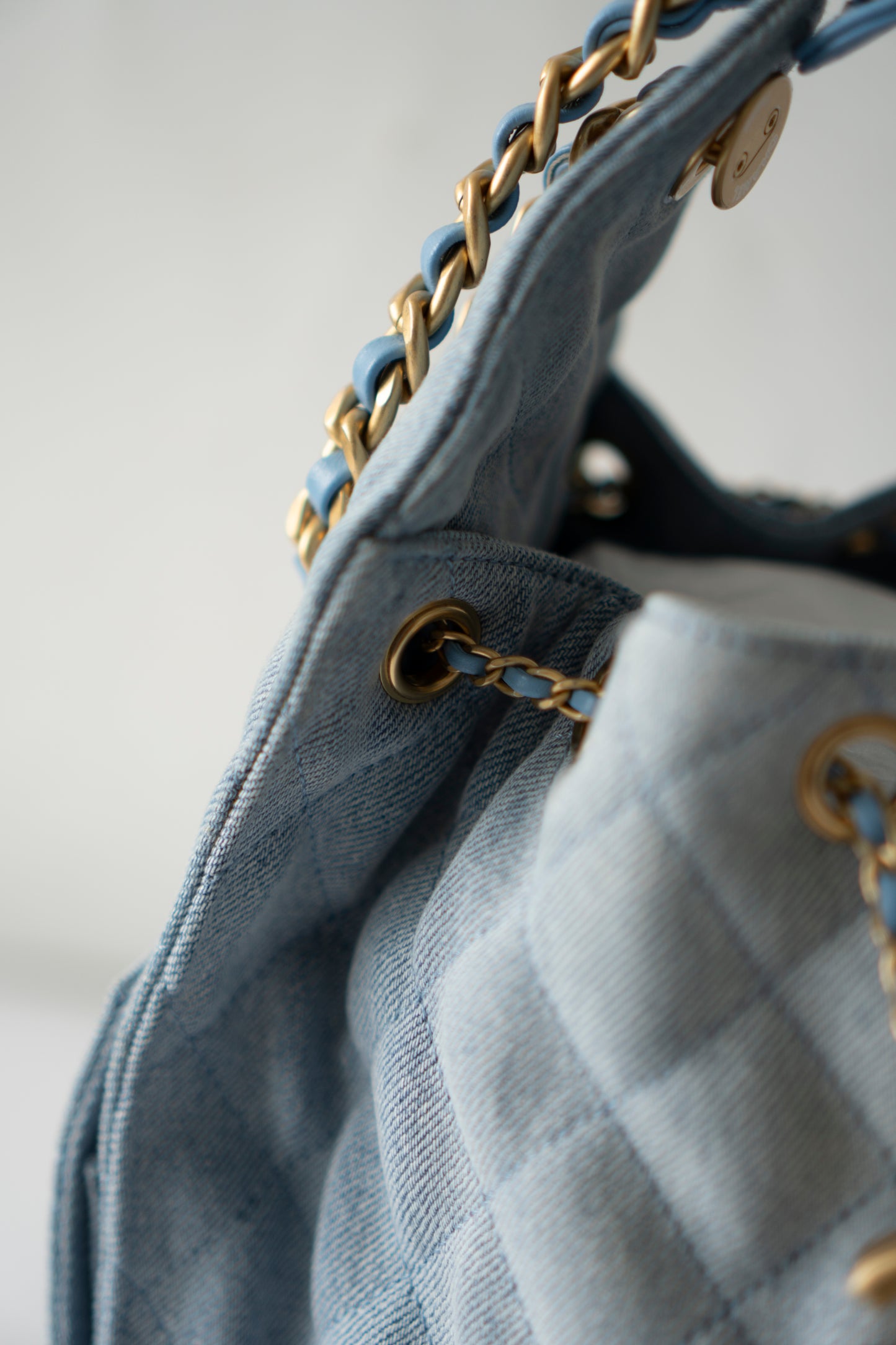 C25 Medium Drawstring Chain Bag – Washed Denim with Gold Hardware