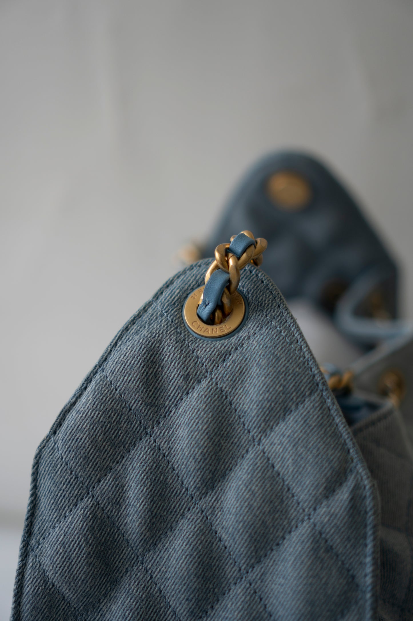 C25 Medium Drawstring Chain Bag – Washed Denim with Gold Hardware