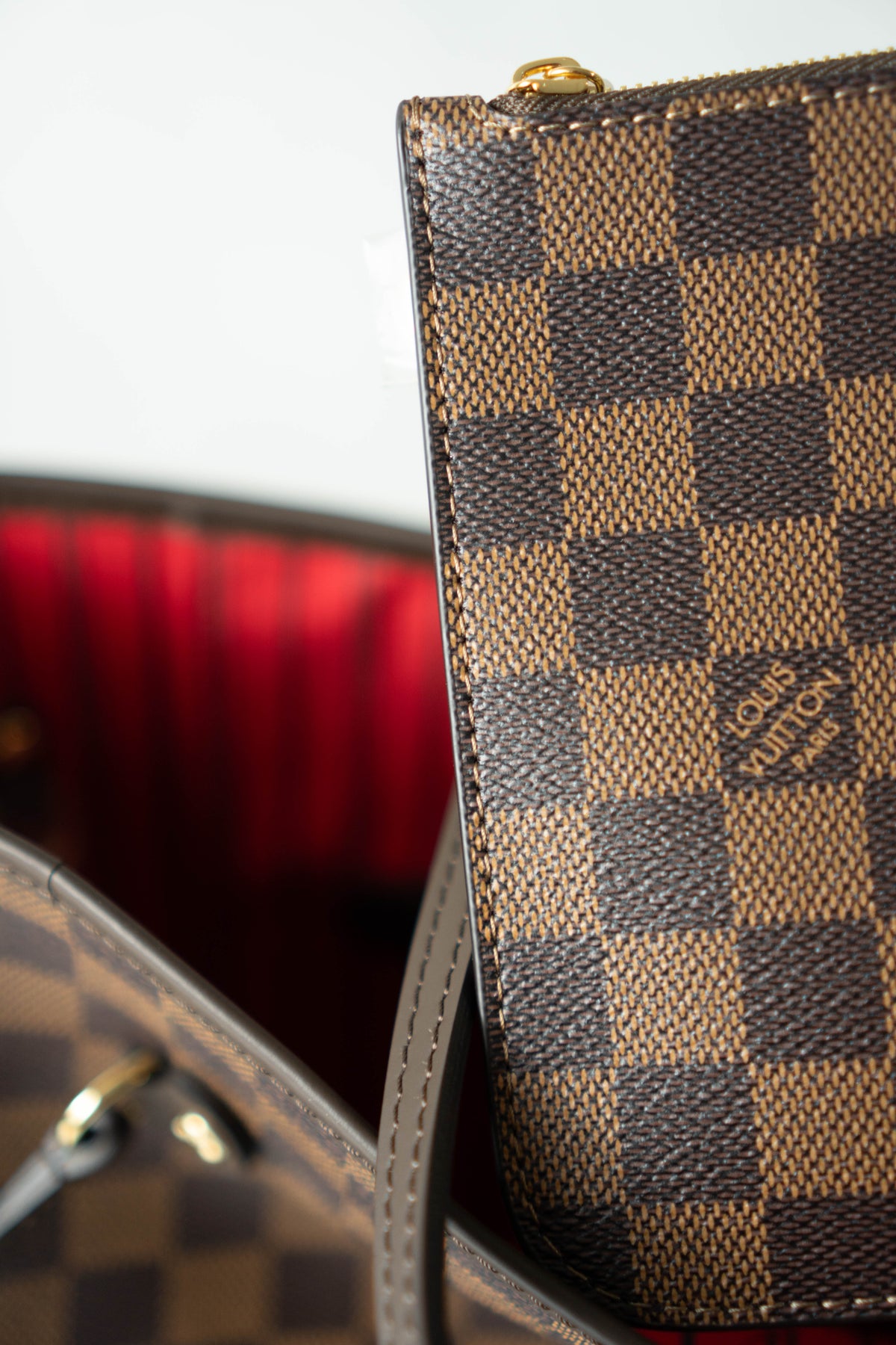 Neverfull MM – Damier Ebene Canvas with Red Interior