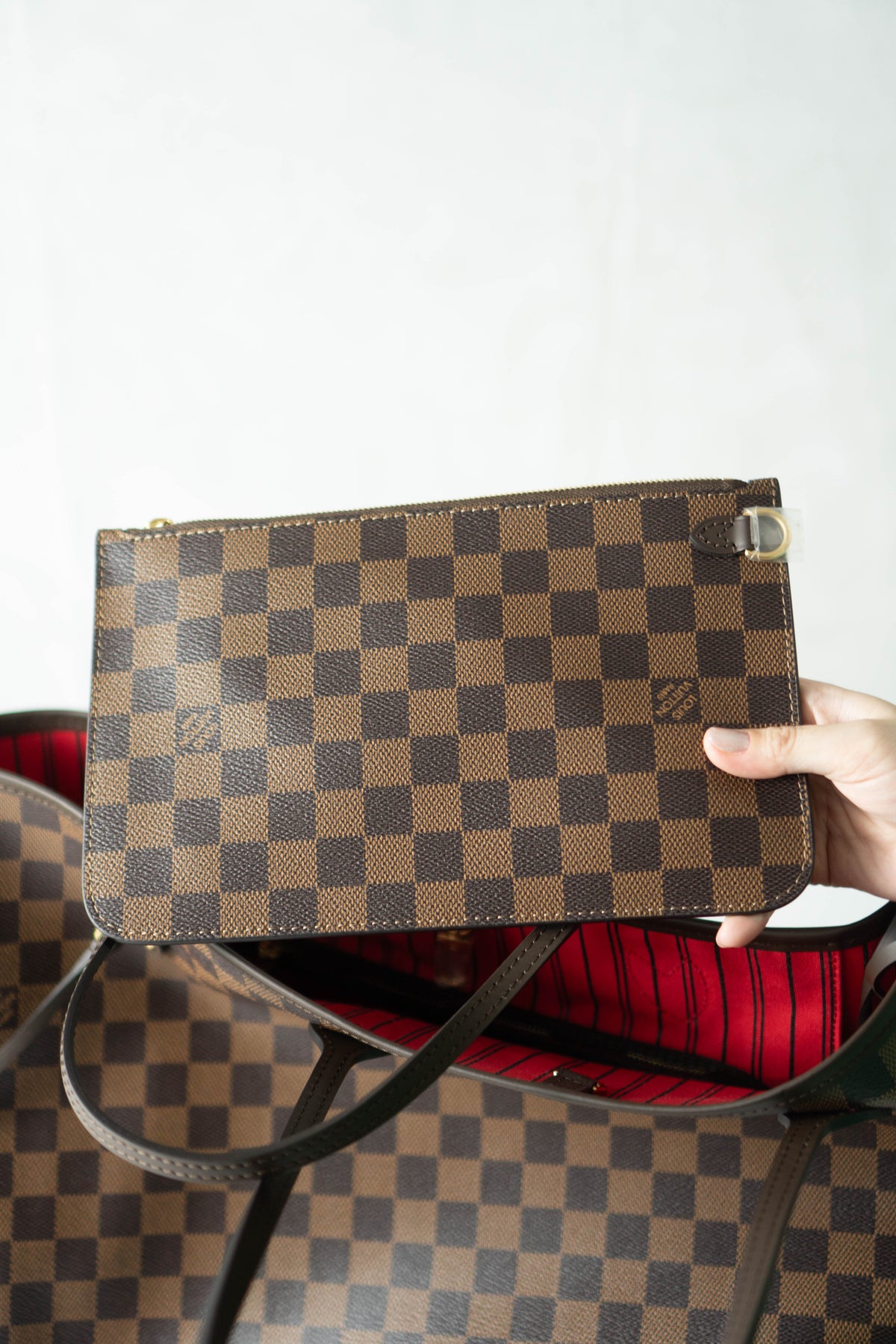 Neverfull MM – Damier Ebene Canvas with Red Interior