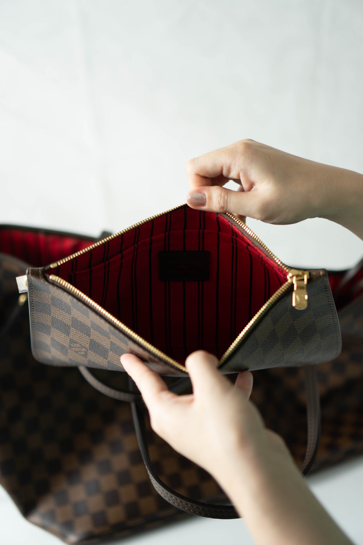 Neverfull MM – Damier Ebene Canvas with Red Interior