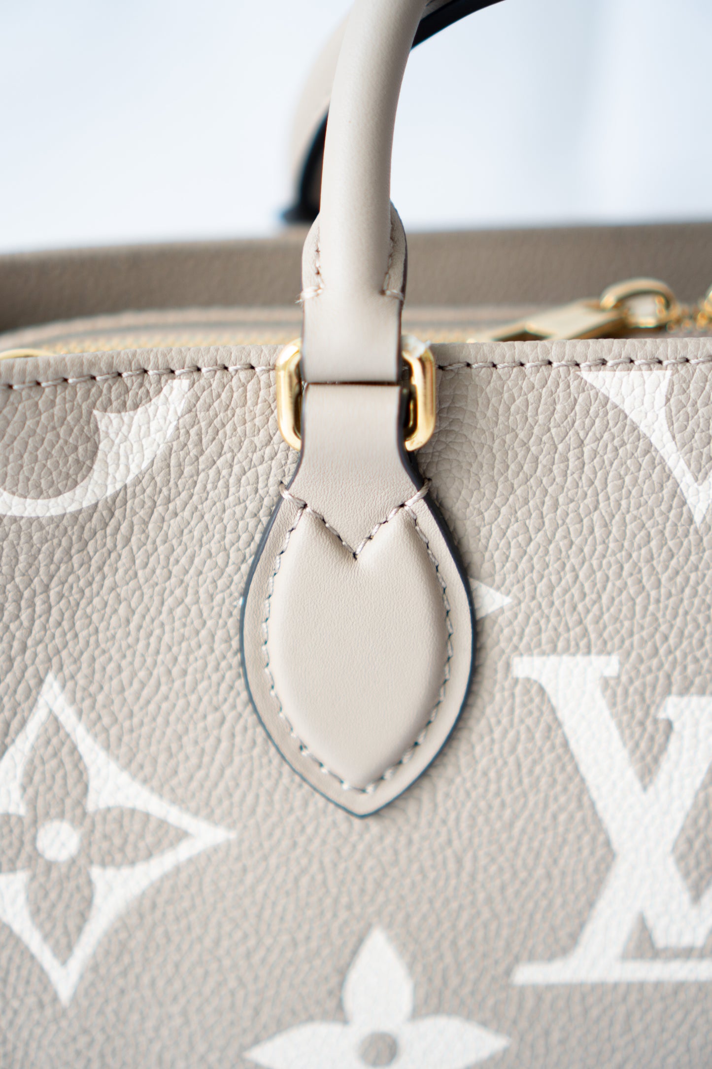 OnTheGo East-West Tote – Tourterelle Monogram Embossed Leather with Gold Hardware