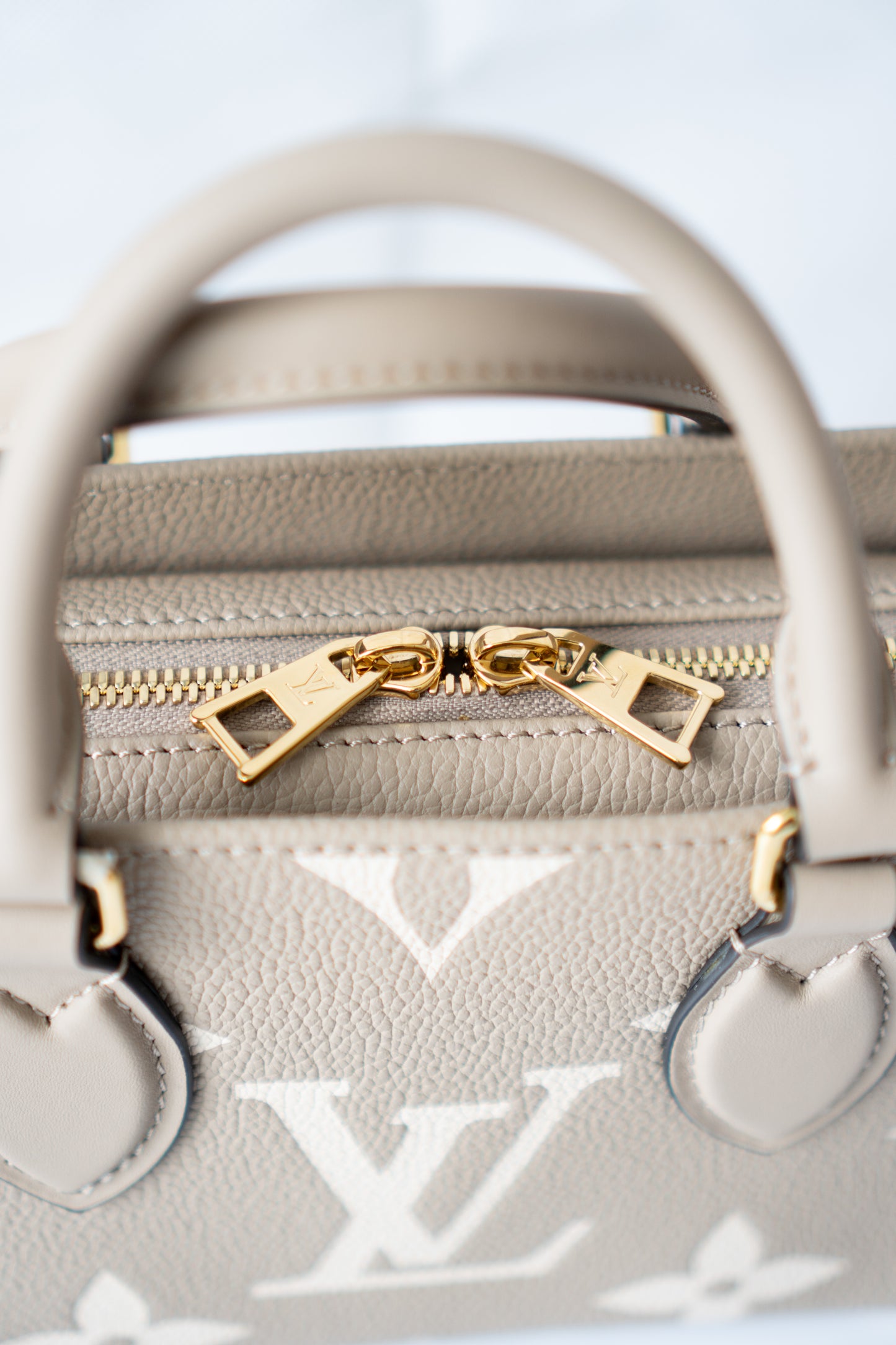 OnTheGo East-West Tote – Tourterelle Monogram Embossed Leather with Gold Hardware