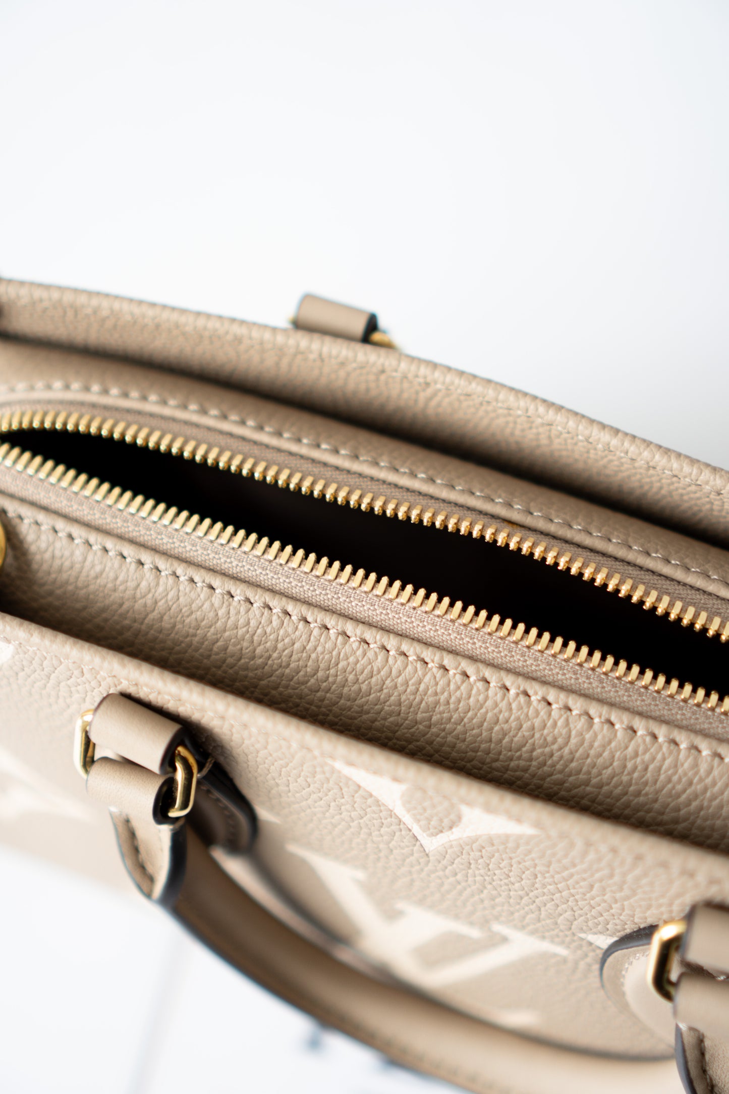 OnTheGo East-West Tote – Tourterelle Monogram Embossed Leather with Gold Hardware