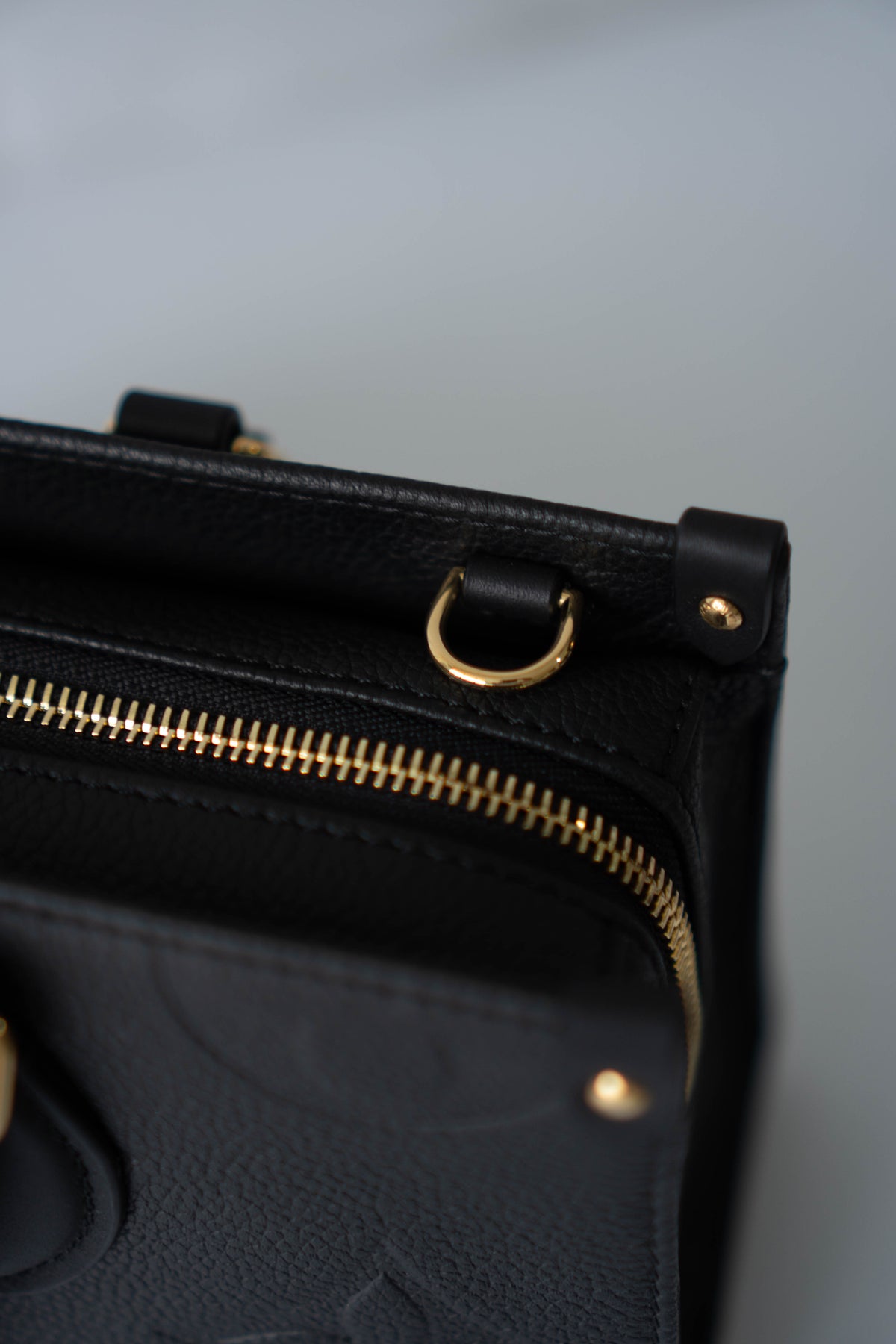 On-The-Go East West – Black Monogram Empreinte Leather with Gold Hardware