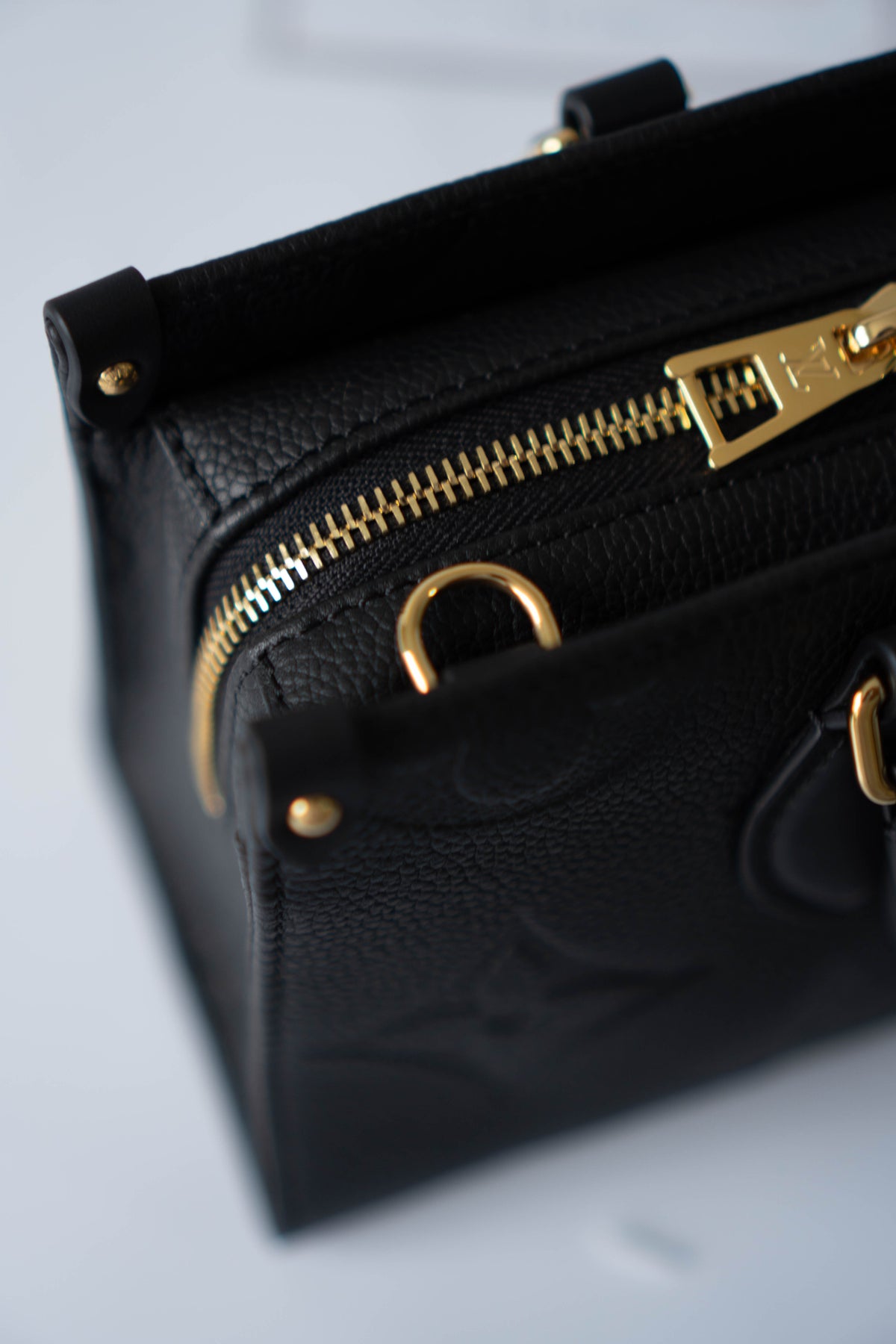 On-The-Go East West – Black Monogram Empreinte Leather with Gold Hardware
